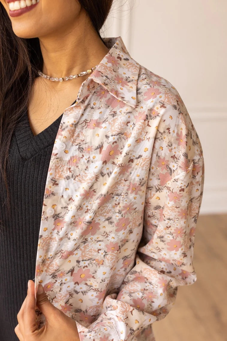 Floral Button-Up Blouse is a charming and feminine wardrobe staple. Featuring a delicate floral print, this unlined blouse offers a lightweight feel and a relaxed fit.