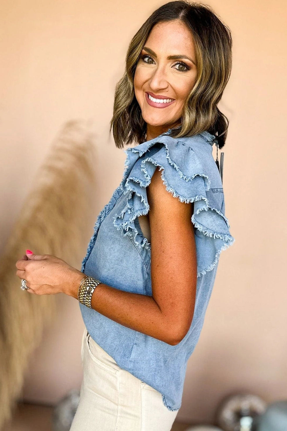 Ruffled Denim Top is a blend of feminine charm and modern style.
