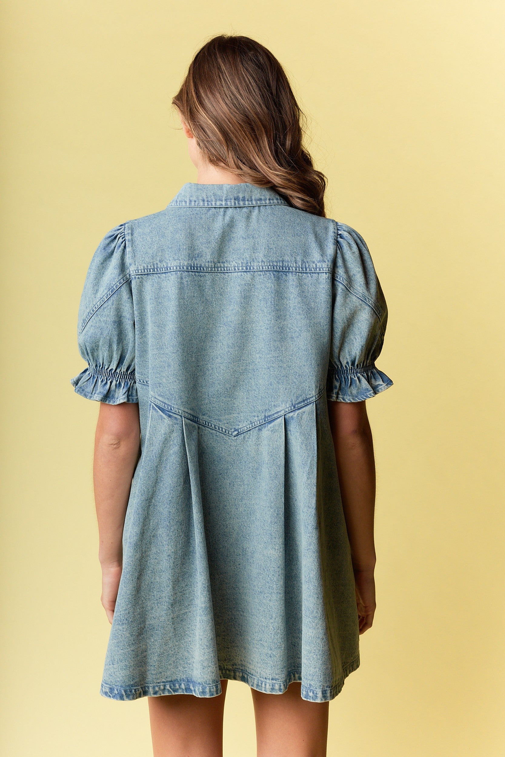 Denim Ruffled Mini Dress is a charming and versatile piece, blending casual comfort with stylish details.