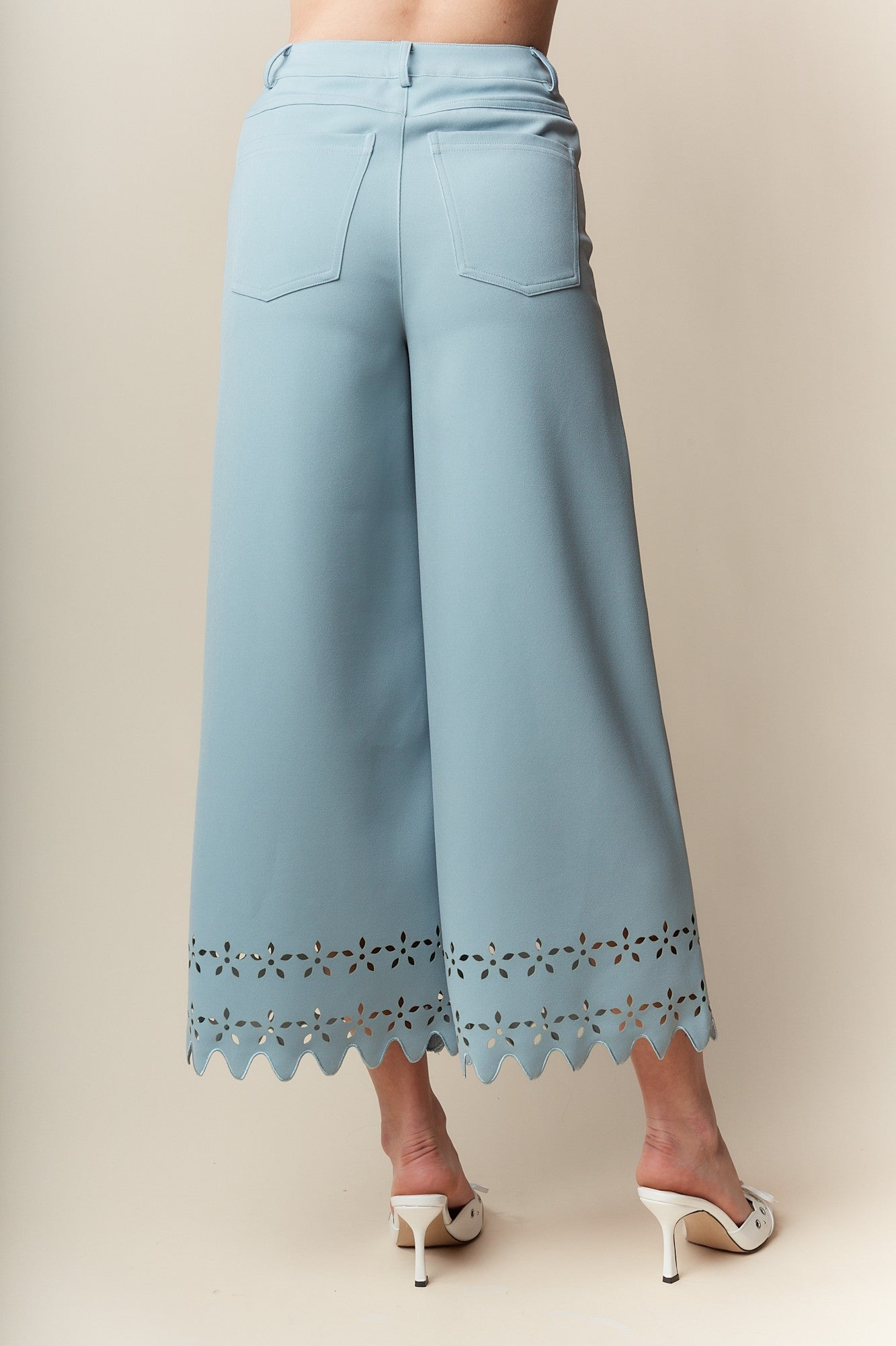 Wide-Leg Pants bring elegance and sophistication to any wardrobe. Designed with a wide-leg, high-waisted fit, these pants feature a delicate laser-cut floral pattern and scalloped hem.