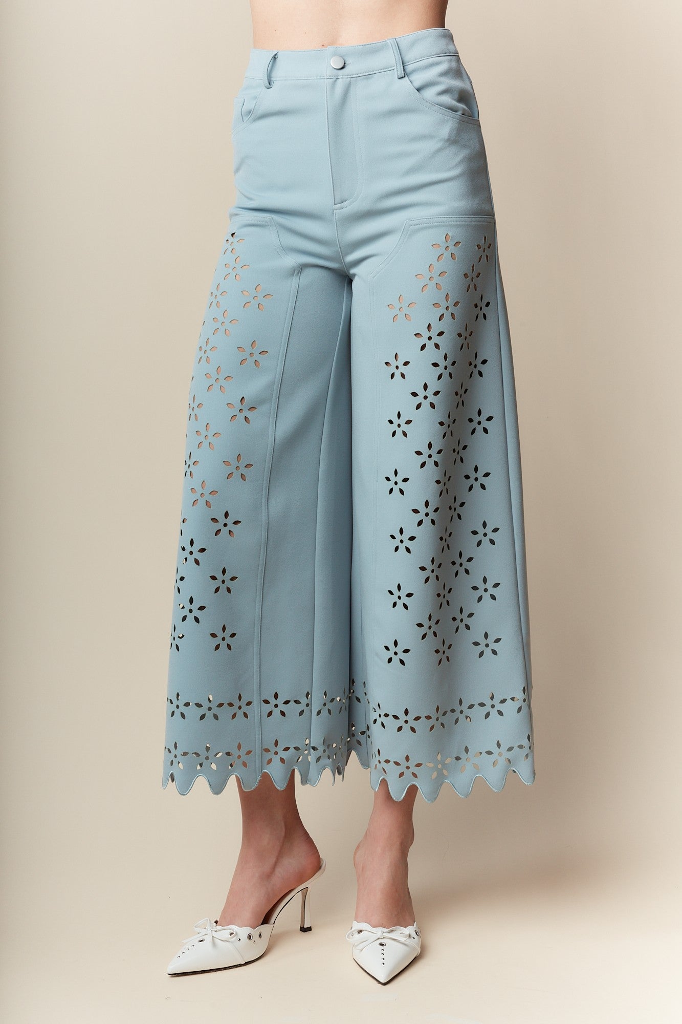 Wide-Leg Pants bring elegance and sophistication to any wardrobe. Designed with a wide-leg, high-waisted fit, these pants feature a delicate laser-cut floral pattern and scalloped hem.