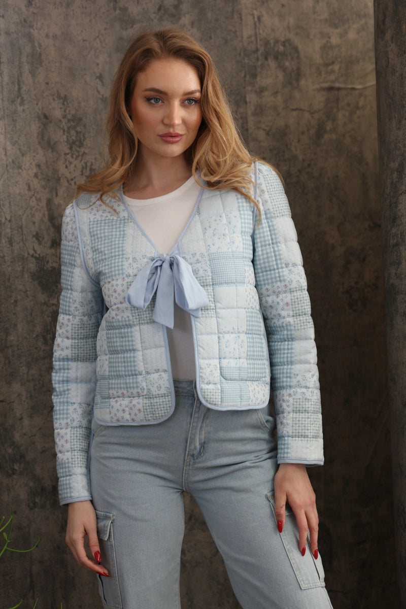 Reversible Quilted Jacket is a versatile and stylish layering piece that combines comfort with timeless charm. Crafted from voile fabric, this jacket features a quilted, patchwork print design and a flattering V-neckline.