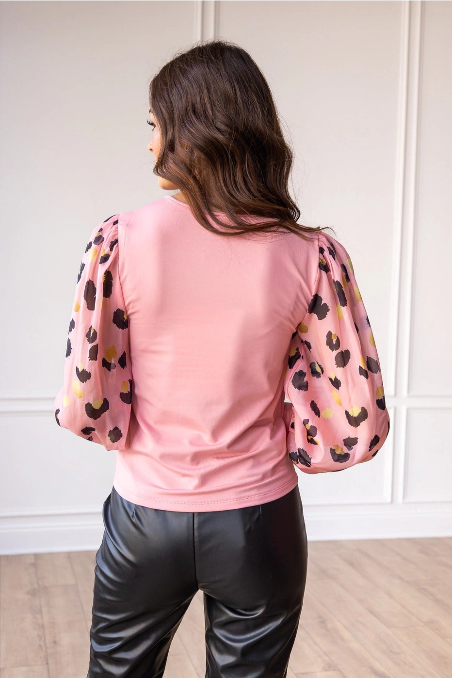 Pink Leopard Sleeve Top is a stylish blend of simplicity and boldness. Featuring sheer leopard-print puff sleeves and a sleek solid bodice.