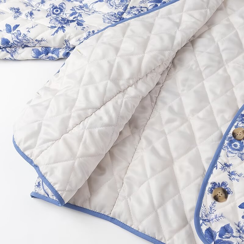 Blue Floral Quilted Jacket is a timeless and elegant piece that offers both style and comfort. Featuring a classic blue-and-white floral pattern, this lightweight quilted jacket is perfect for layering during cooler seasons.