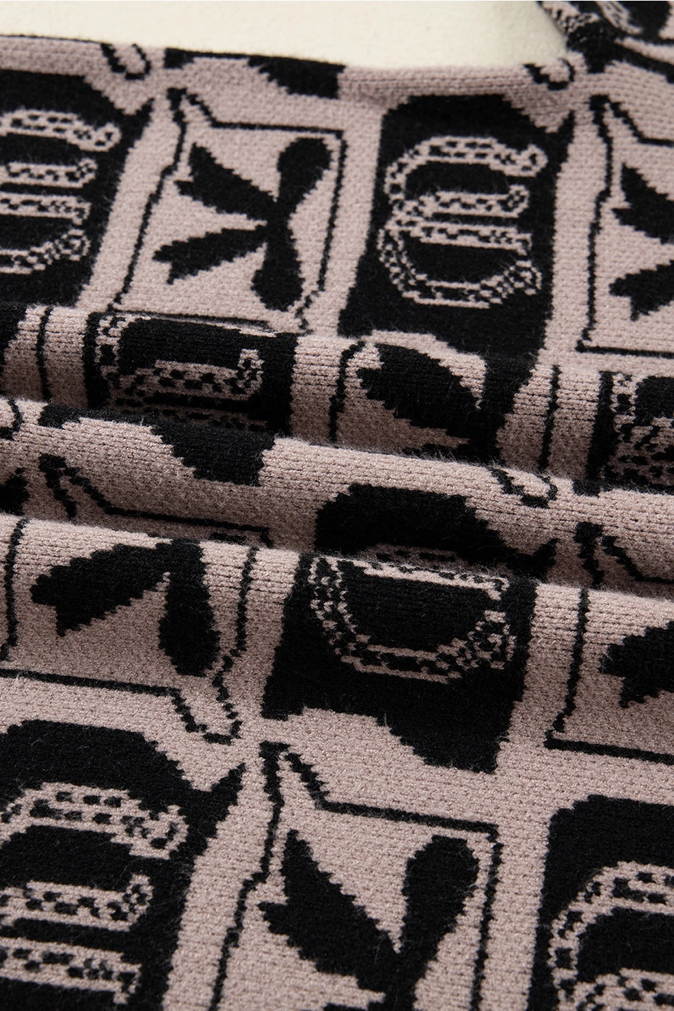 Western Print Sweater makes a bold statement with its unique bows and horseshoes pattern.