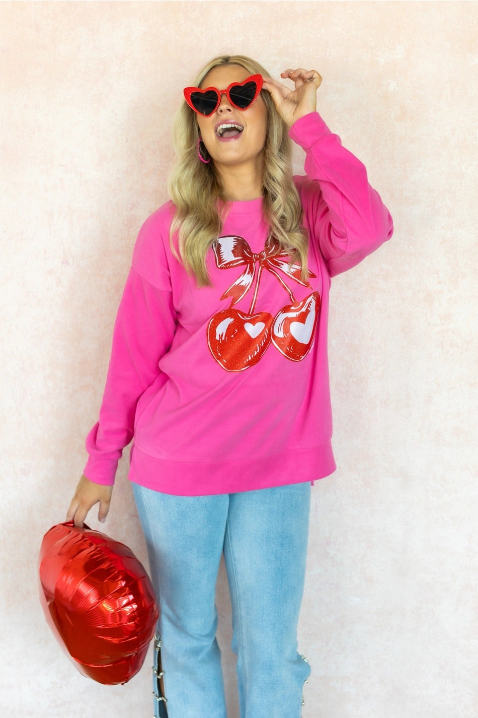 Cherry Graphic Sweatshirt is a fun and bold statement piece. Designed with an oversized fit, split hem.