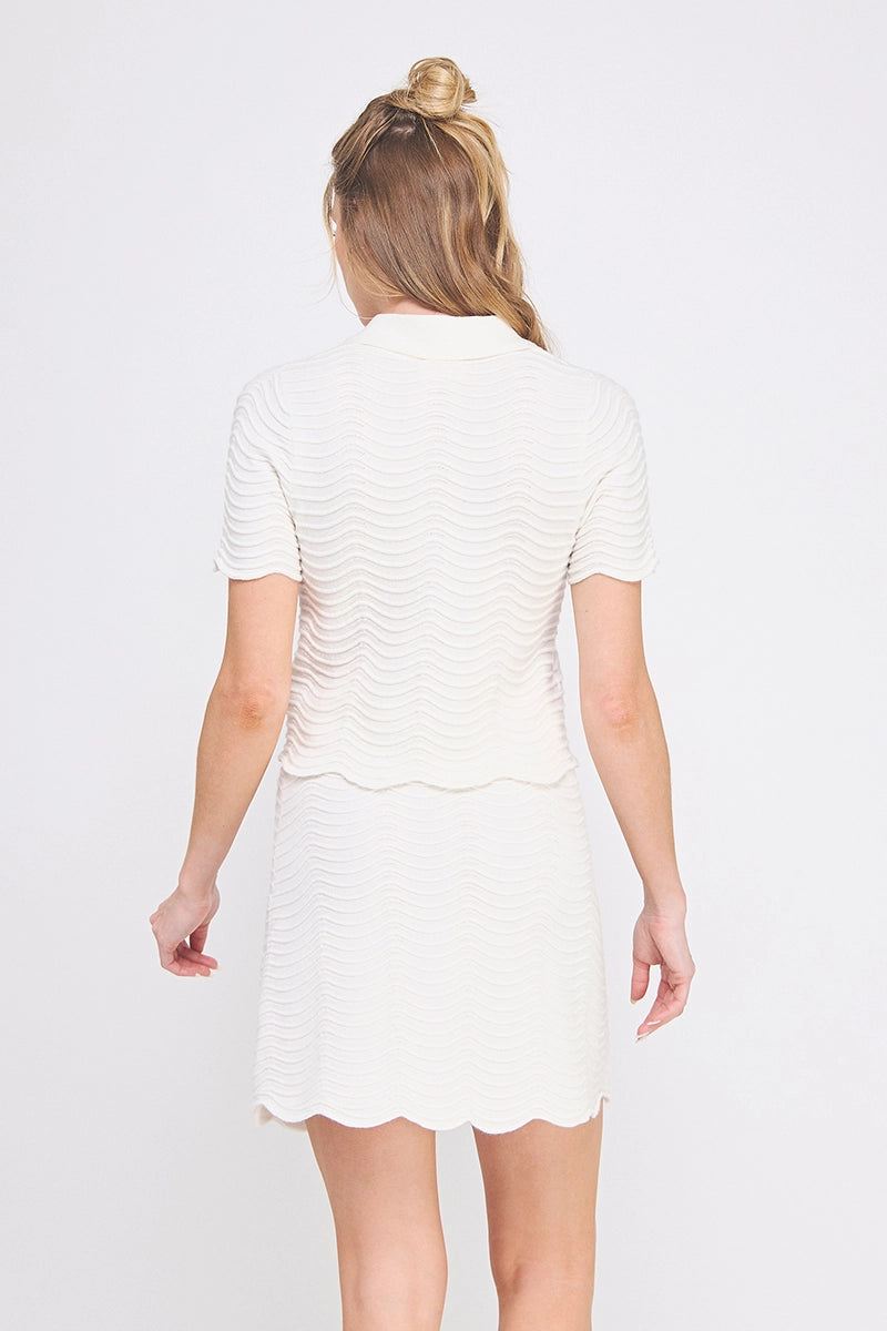 Cream Scallop Knit Polo Top is a sophisticated blend of elegance and comfort.