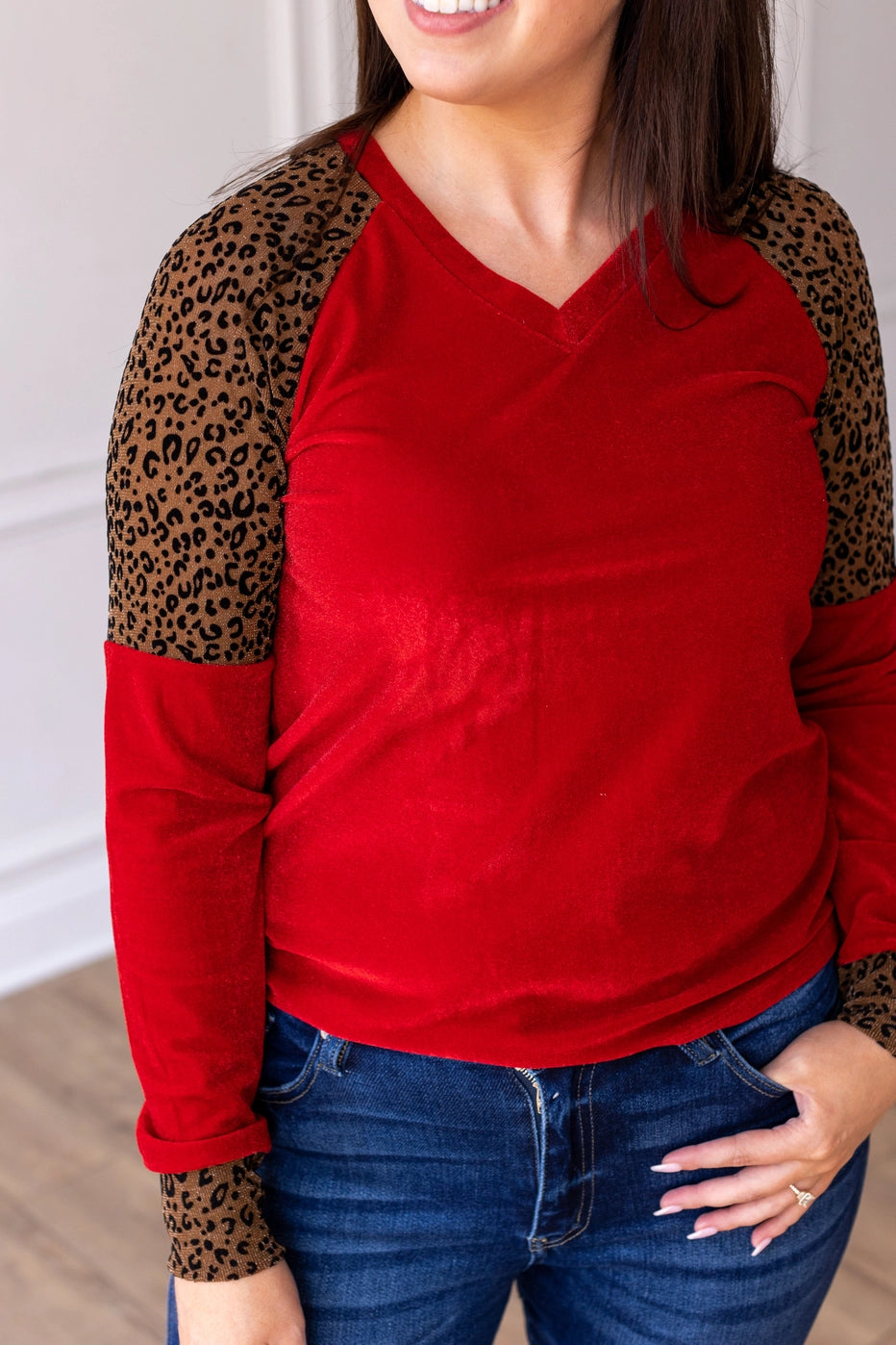 Red Velvet Top is a bold and stylish choice for any wardrobe. Featuring a luxurious red velvet body paired with leopard print accents on the sleeves and cuffs.