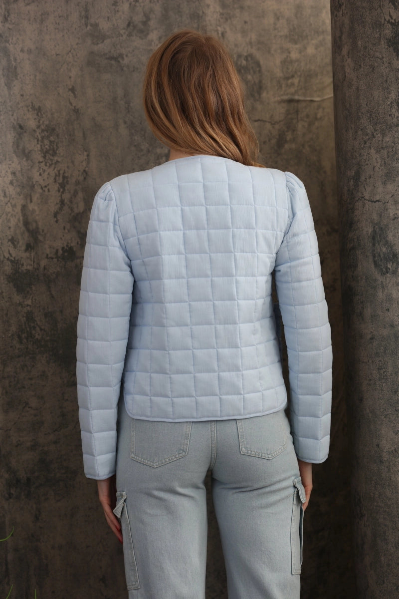 Reversible Quilted Jacket is a versatile and stylish layering piece that combines comfort with timeless charm. Crafted from voile fabric, this jacket features a quilted, patchwork print design and a flattering V-neckline.