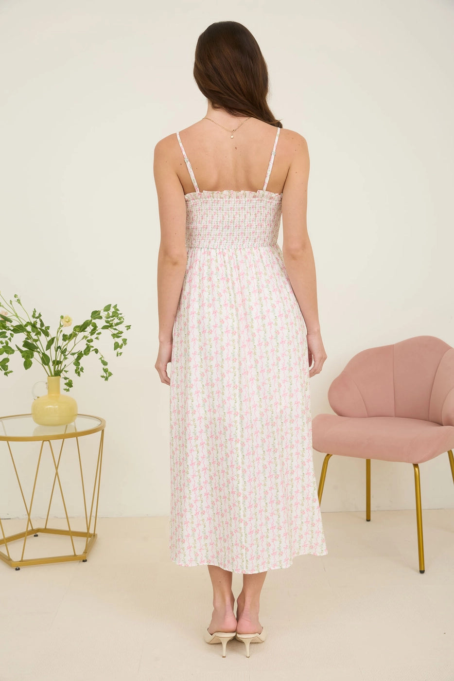 Pink Floral Bow Midi Dress. Featuring a square neckline with ruffle trim and adjustable spaghetti straps.
