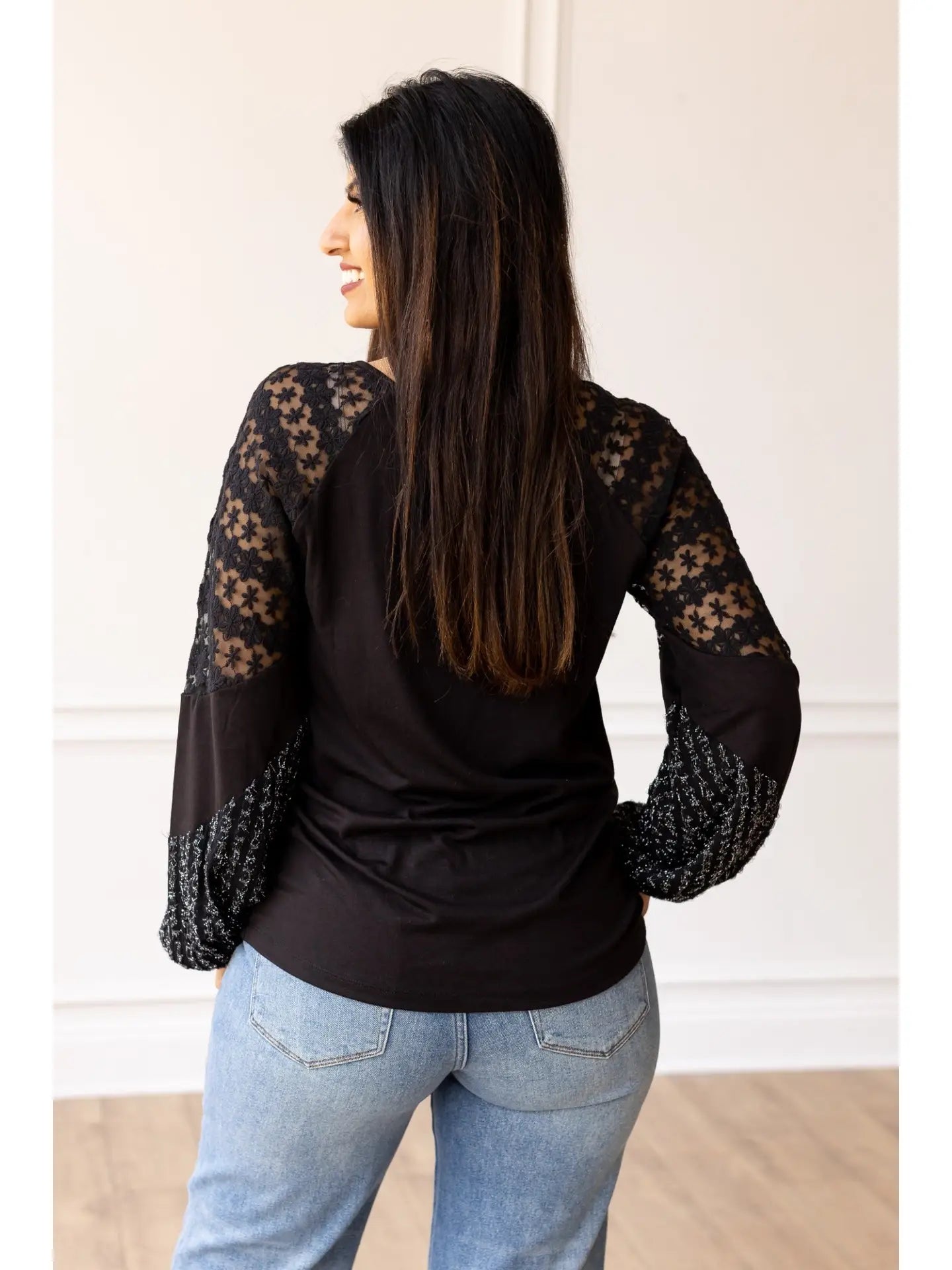 Lace Sleeve Top combines classic elegance with modern flair. This true-to-size top features intricate lace detailing on the sleeves and a softly flared cuff.