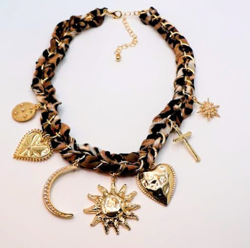 This stunning necklace features a unique braided design adorned with an array of charming pendants, including celestial motifs and intricate symbols.