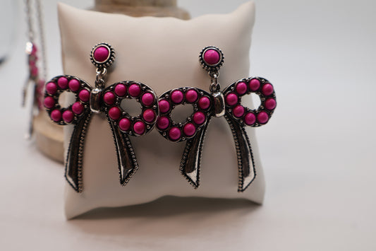 These playful earrings feature charming round bead details, showcasing a bold, vintage-inspired design.