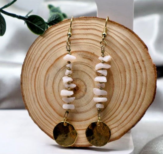 A pair of earrings Featuring a delicate fishhook design, these earrings are adorned with charming beads and a polished round charm. Measuring 3 inches in length.