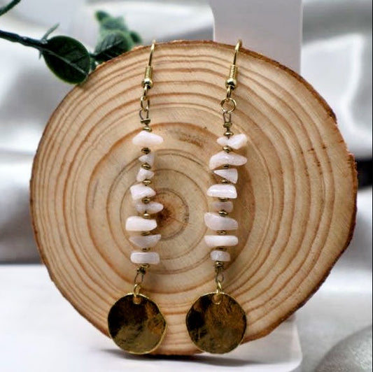 A pair of earrings Featuring a delicate fishhook design, these earrings are adorned with charming beads and a polished round charm. Measuring 3 inches in length.