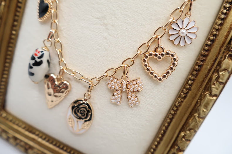 Bow Pendant Necklace is a refined and graceful piece, designed to add a touch of understated elegance to your look. Featuring three petite bow-shaped charms on a delicate gold-tone chain.