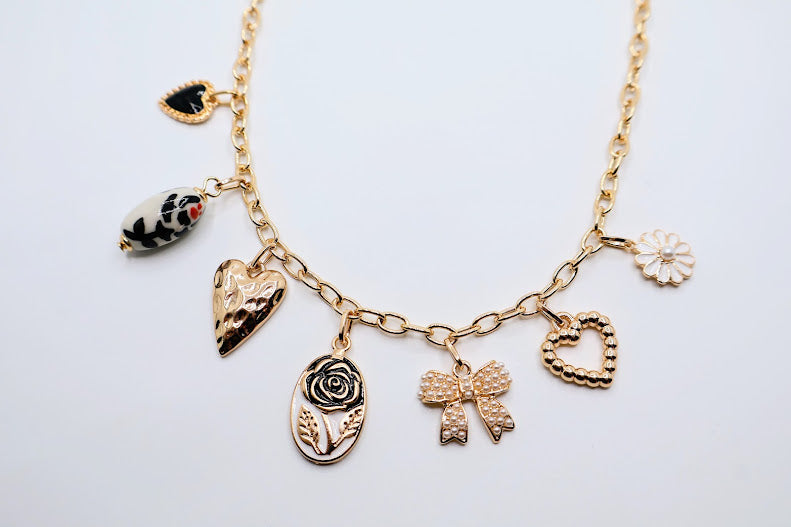 Bow Pendant Necklace is a refined and graceful piece, designed to add a touch of understated elegance to your look. Featuring three petite bow-shaped charms on a delicate gold-tone chain.