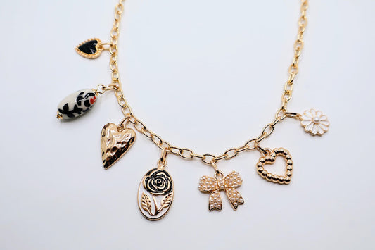 Bow Pendant Necklace is a refined and graceful piece, designed to add a touch of understated elegance to your look. Featuring three petite bow-shaped charms on a delicate gold-tone chain.