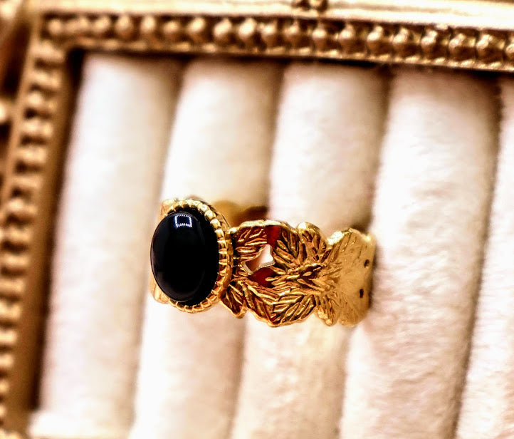 Ring is a bold yet elegant statement piece, designed for those who embrace their unique style. Featuring a striking oval black stone framed by textured gold-tone detailing.