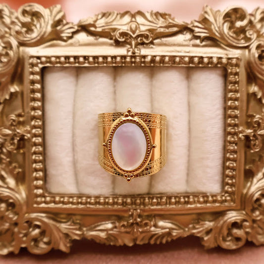 Ring is a masterpiece of feminine elegance and celestial charm. Featuring a lustrous oval pearl-like centerpiece.