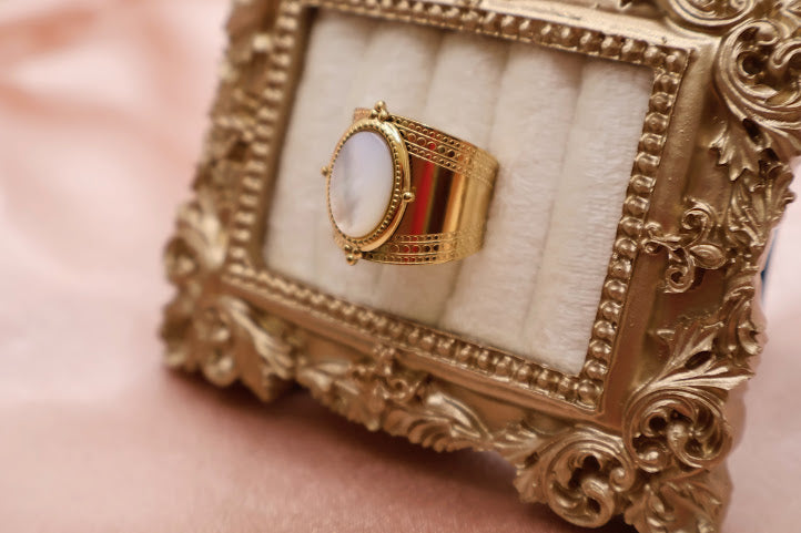 Ring is a masterpiece of feminine elegance and celestial charm. Featuring a lustrous oval pearl-like centerpiece.