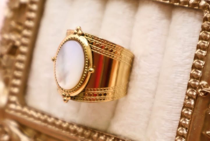 Ring is a masterpiece of feminine elegance and celestial charm. Featuring a lustrous oval pearl-like centerpiece.