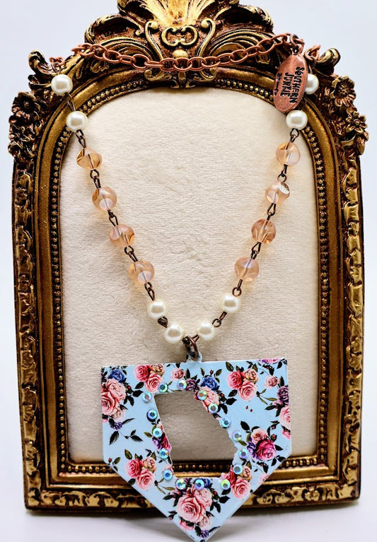 Georgia State Charm Statement Necklace. Featuring a delightful floral pendant, peach bead accents, and a rose gold chain.