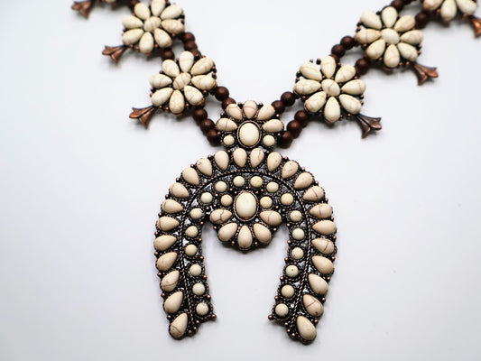 Boho design necklace features charming flower-shaped accents interspersed with rich, earthy beads.