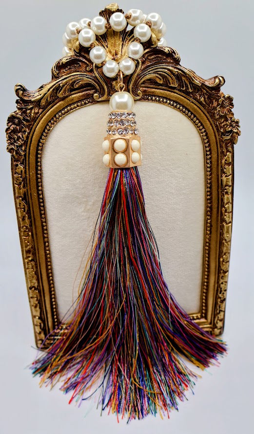 Pearl  tassel necklace features a vibrant multi-colored tassels that flow beautifully from a classic strand of elegant pearls.