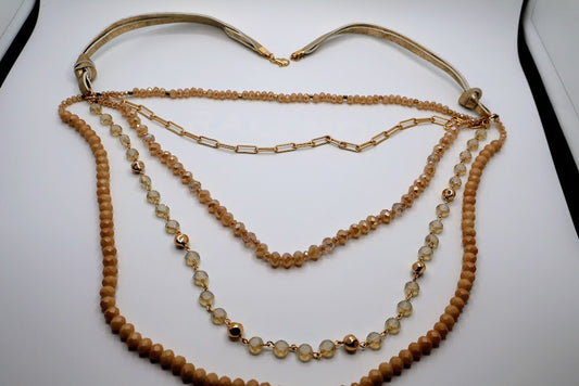 Multi-layerded Necklace featuring strands of ivory-toned beads, shimmering chains, and delicate gold accents.
