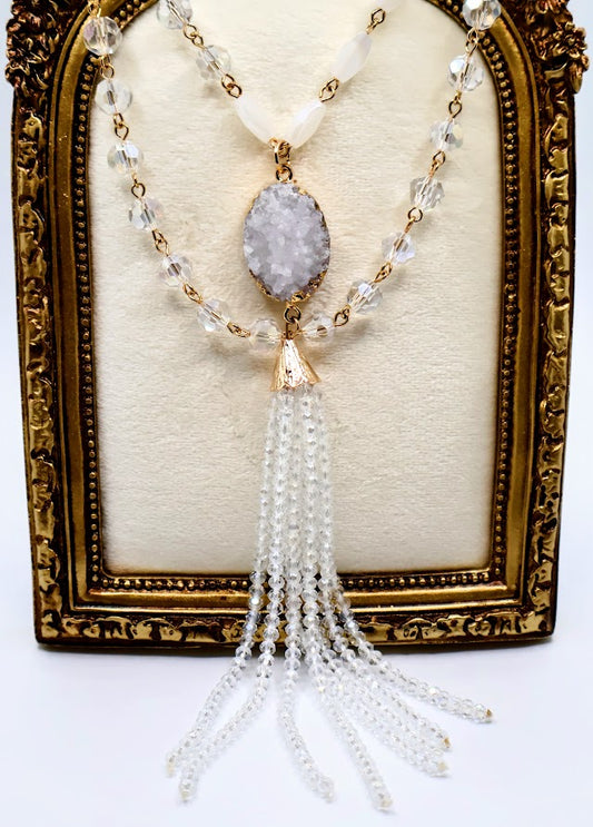 Necklace with a combination of shimmering beads, druzy pendant, and tasseled beads.