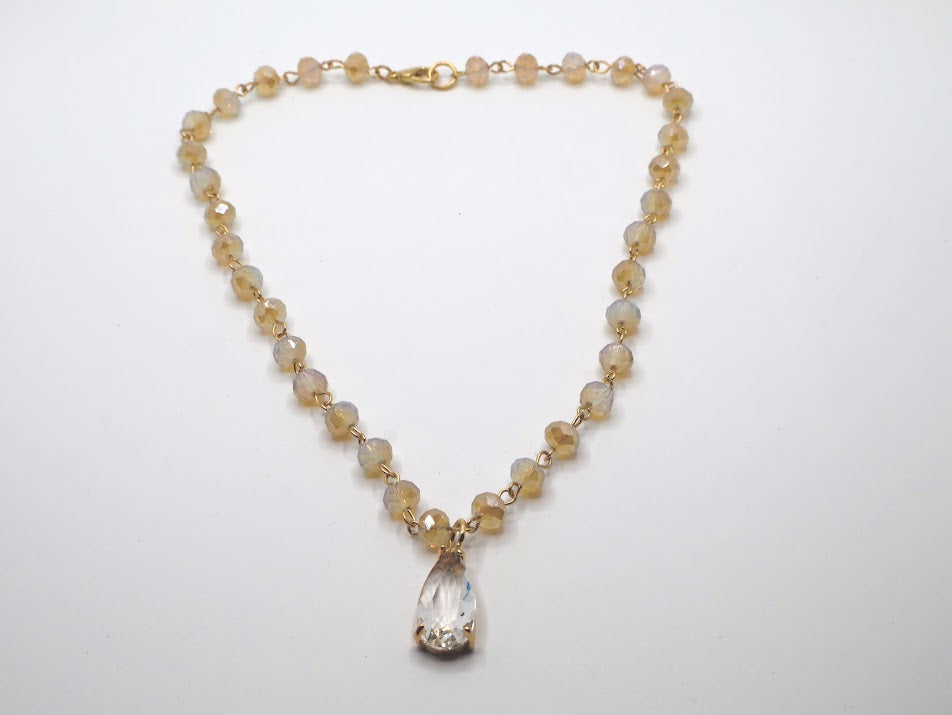 Necklace featuring radiant beads and a stunning teardrop pendant.