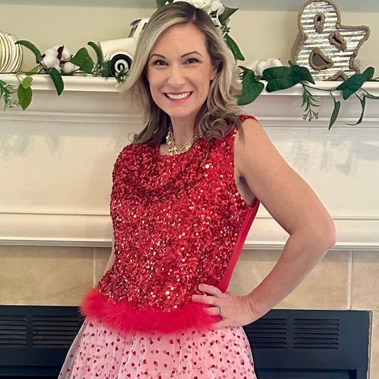 Sequin Feather Crop Top is a bold and glamorous statement piece. Featuring shimmering red sequins and a playful feathered hem.