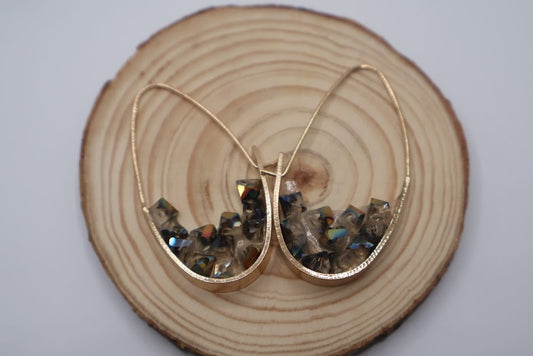 Gold geometric shape earrings with embedded stones.