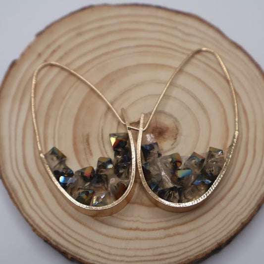 Gold geometric shape earrings with embedded stones.