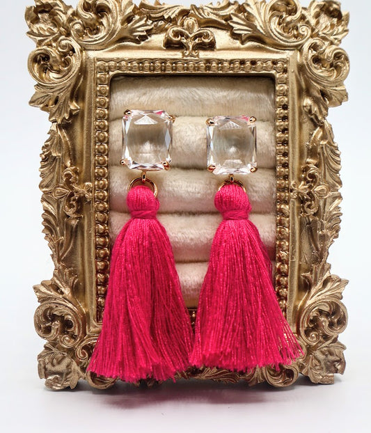 Pink tassel earrings featuring sparkling crystal studs.
