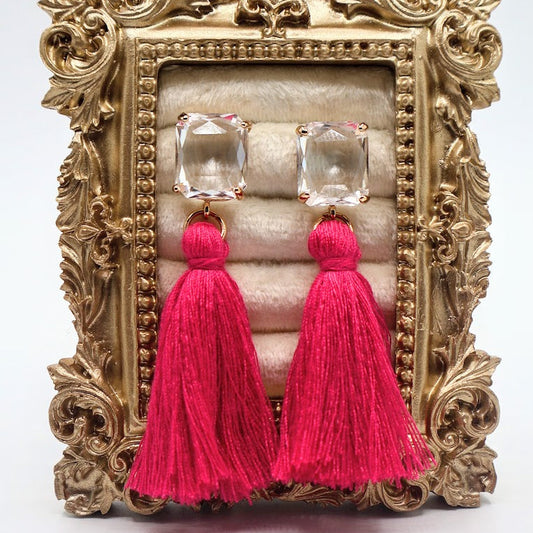Pink tassel earrings featuring sparkling crystal studs.