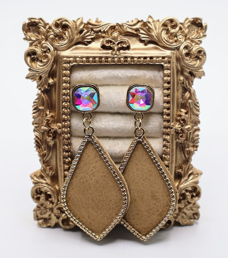 Pair of earrings with colorful gemstones and brown teardrop shapes on a decorative gold stand.
