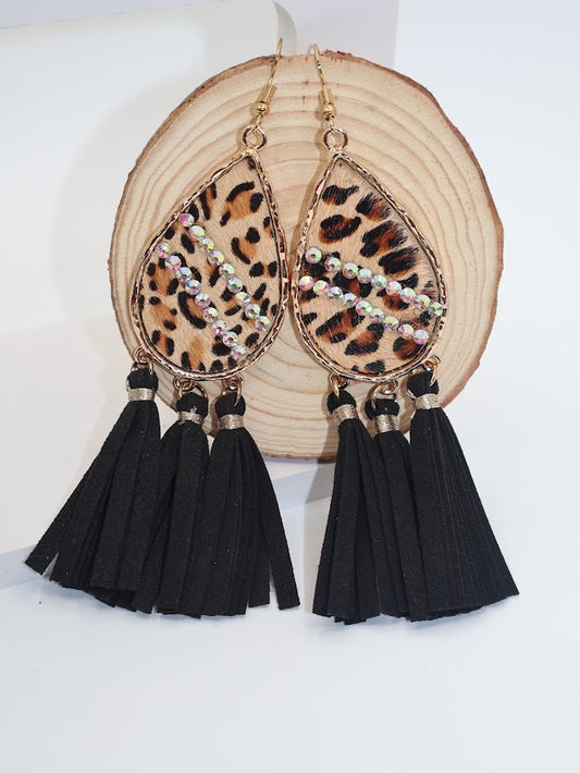 Leopord-print teardrop earrings adorned with hints of sparkle and framed in gold and tassels.