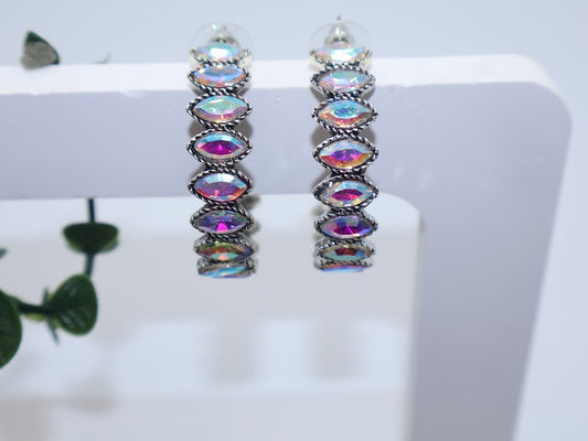 Multicolored gemstone hoop earrings adorned with glimmering pear-shaped crystal and metallic accents.