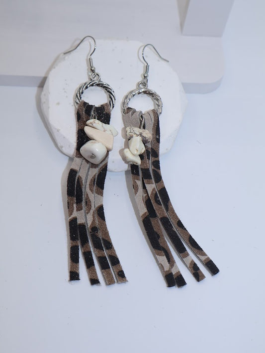 Pair of earrings with leopard print tassels and white beads.