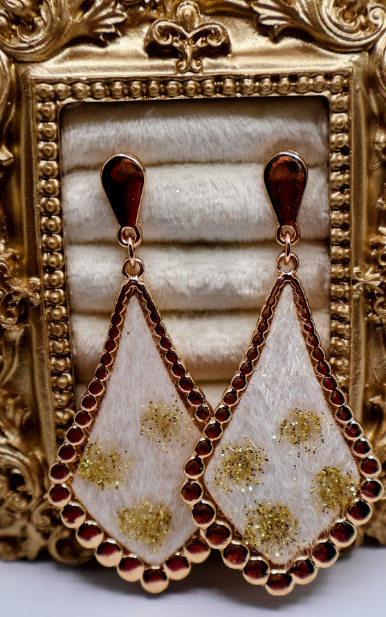 Ivory Gold-Dusted Earrings featuring a stunning ivory-toned teardrop design, delicately dusted with golden floral accents and framed by a shimmering beaded edge.