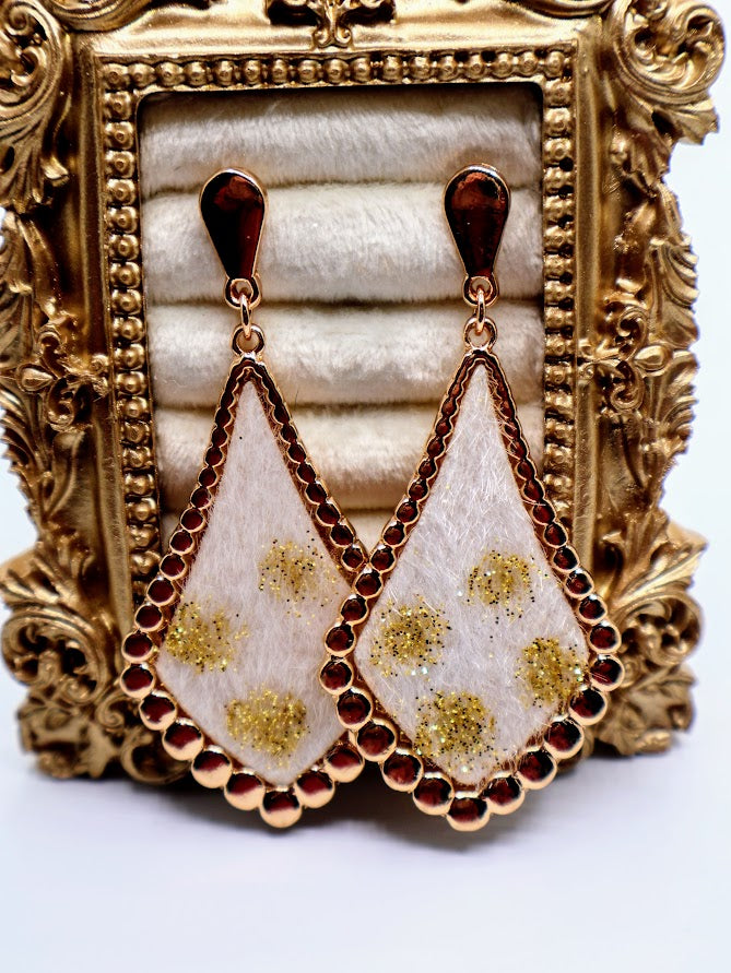Ivory Gold-Dusted Earrings featuring a stunning ivory-toned teardrop design, delicately dusted with golden floral accents and framed by a shimmering beaded edge.