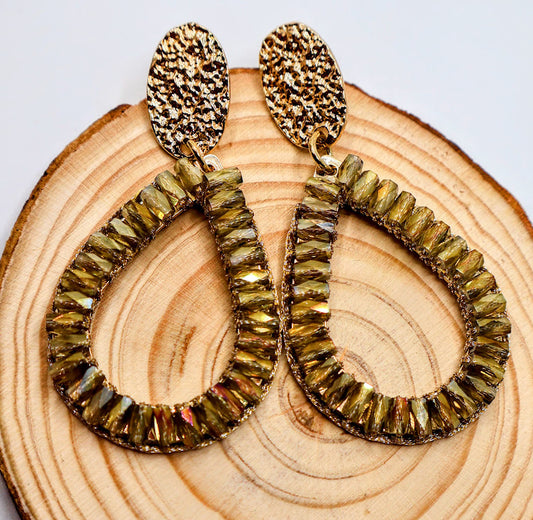 Teardrop-shaped earrings feature delicately woven golden accents, reminiscent of cascading petals.