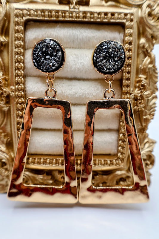 Gold and gray earrings feature a bold geometric design with a hammered gold finish.