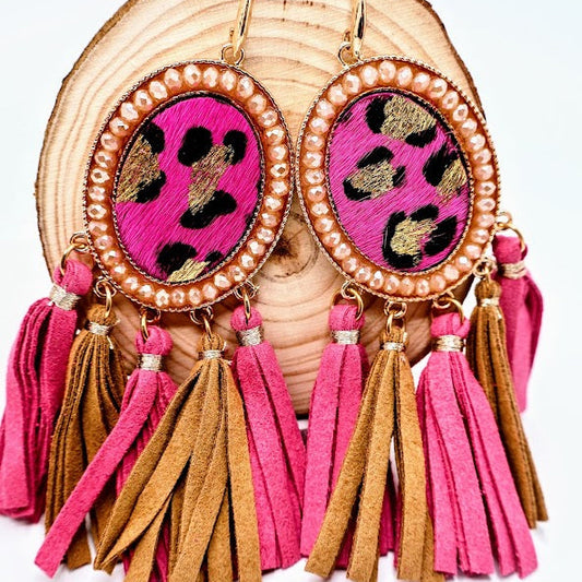 Earrings with pink and gold tassels and leopard print design on a white background