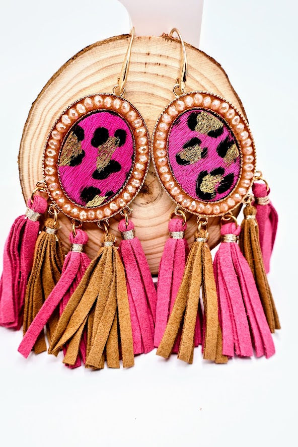 Earrings with pink and gold tassels and leopard print design on a white background
