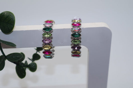 Multicolored gemstone hoop earrings metallic accents.