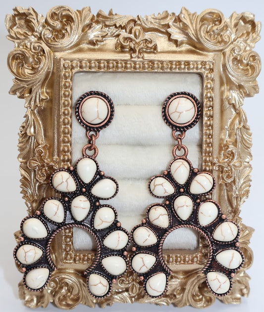 Boho Horseshoe earrings. Featuring a unique horseshoe-inspired design adorned with delicate white stones and intricate metallic accents.