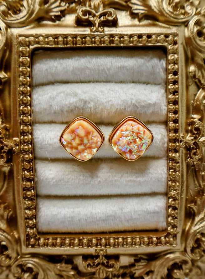 A pair of Coral Studs showcase a dazzling druzy texture that shimmers with natural brilliance.